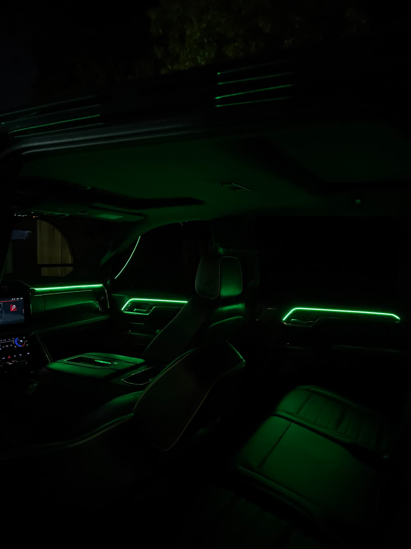 Green ambient lighting across the dash and doors